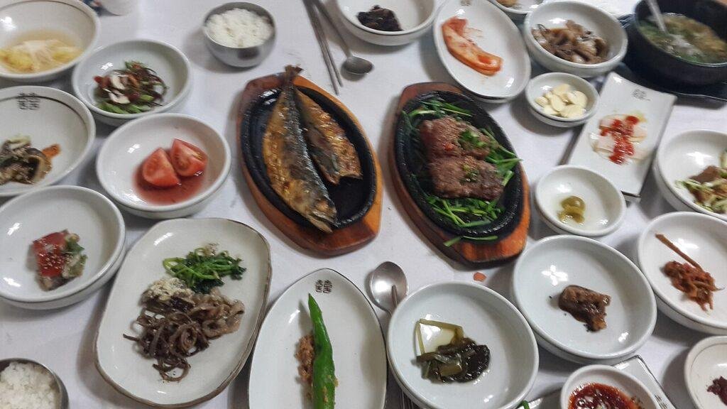 A hanjeongsik table in Damyang, South Korea: rice, soup, grilled fish, grilled meat and many small banchan dishes served at once